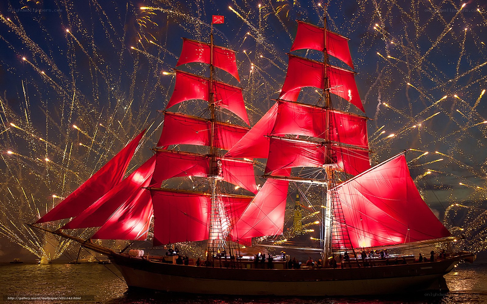 Sailboat with red sails at night