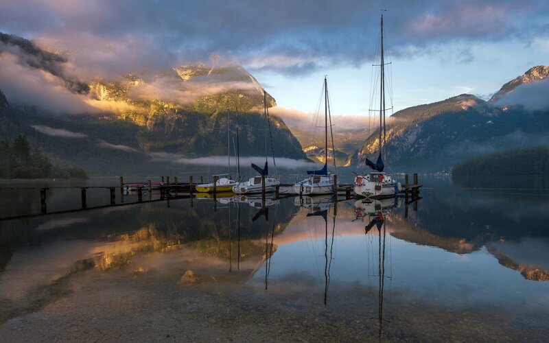 Sailboats at dawn on a mountain lake