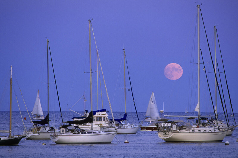 Sailboats at dusk with full moon