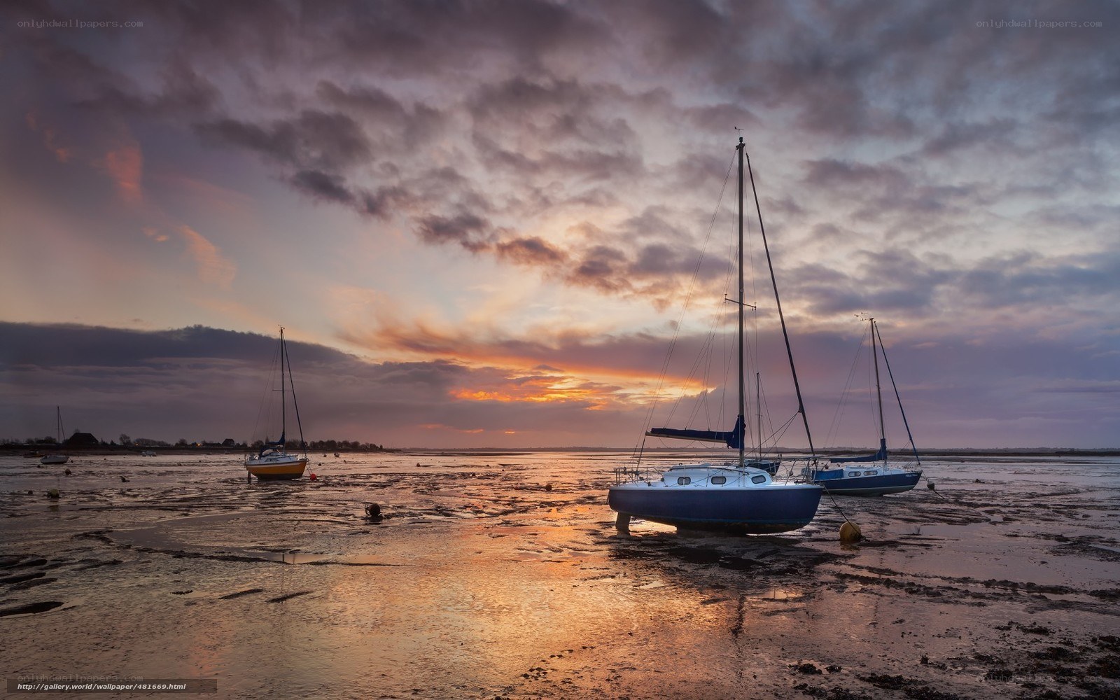 Sailboats at low tide sunset