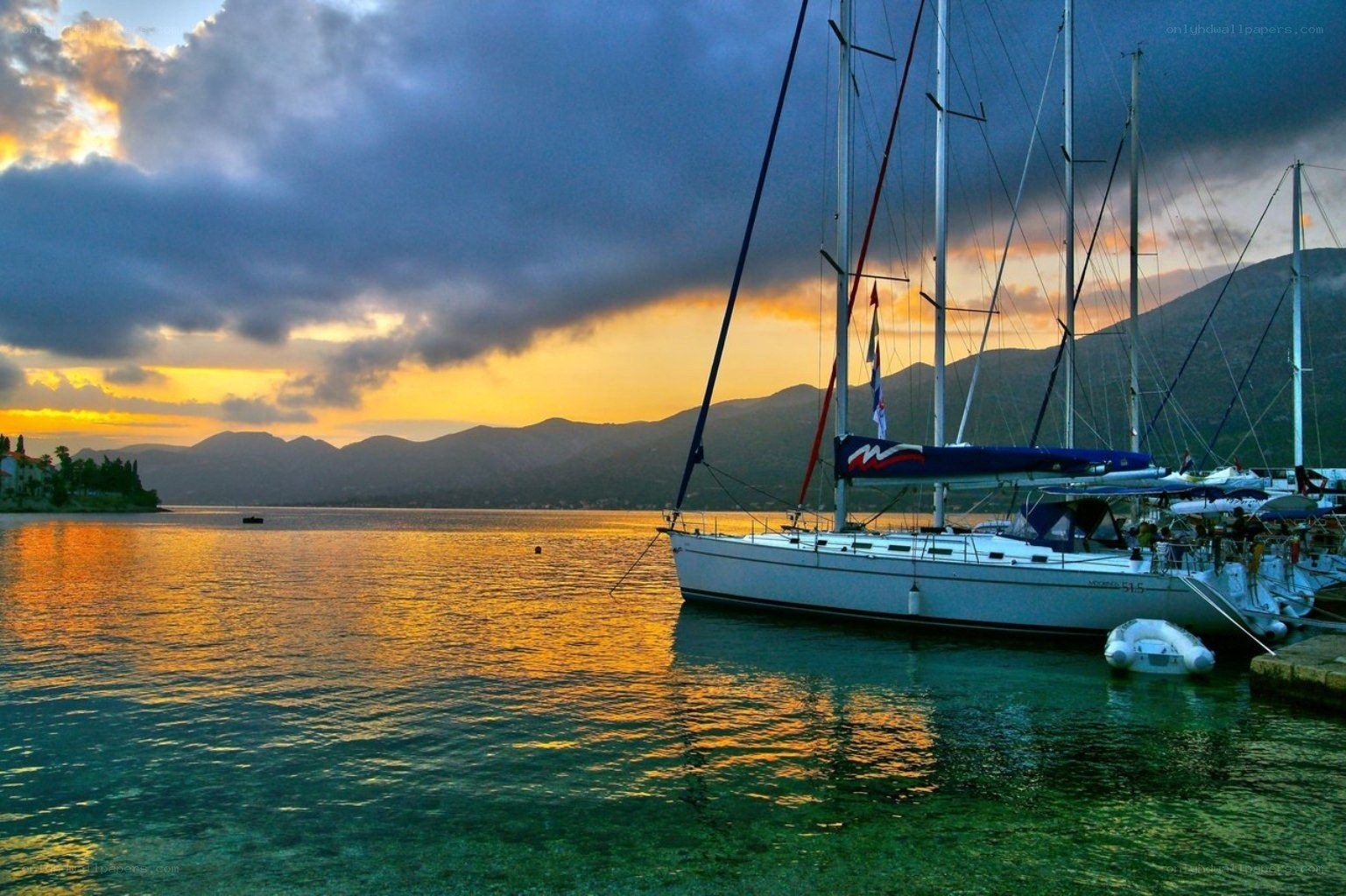 Sailboats at sunset in a bay