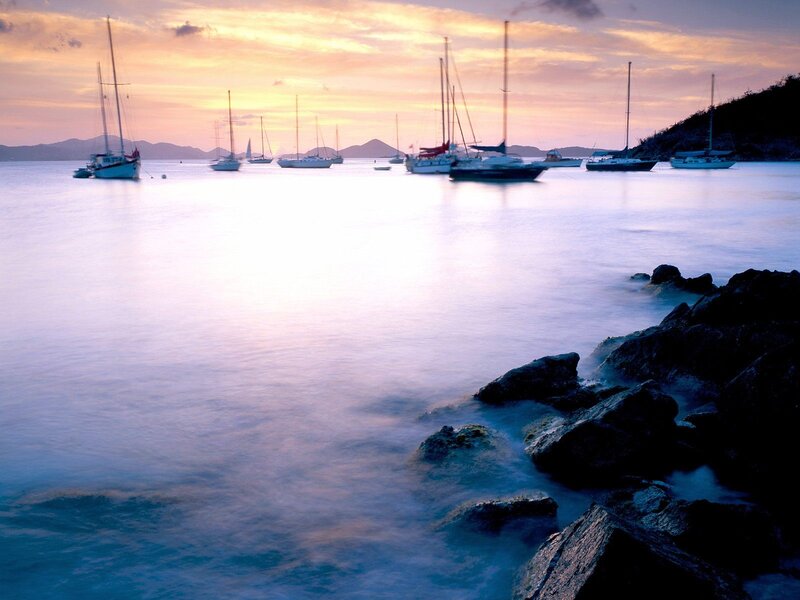 Sailboats at sunset in a calm bay