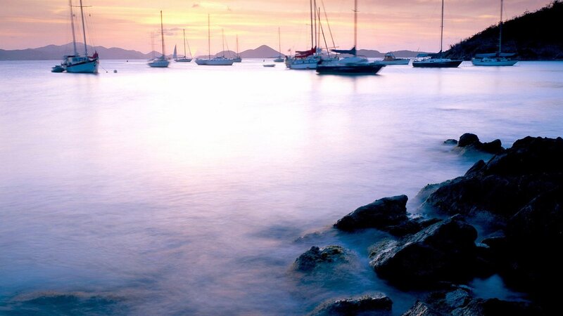 Sailboats at sunset in a calm bay