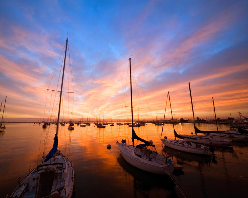 Sailboats at sunset in a harbor