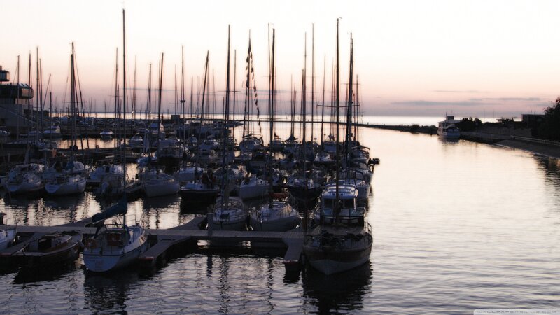 Sailboats at sunset in a harbor