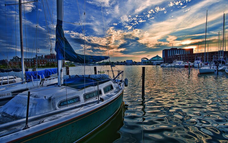 Sailboats at sunset in harbor