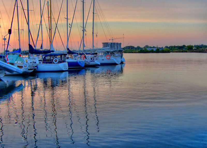 Sailboats at sunset in marina