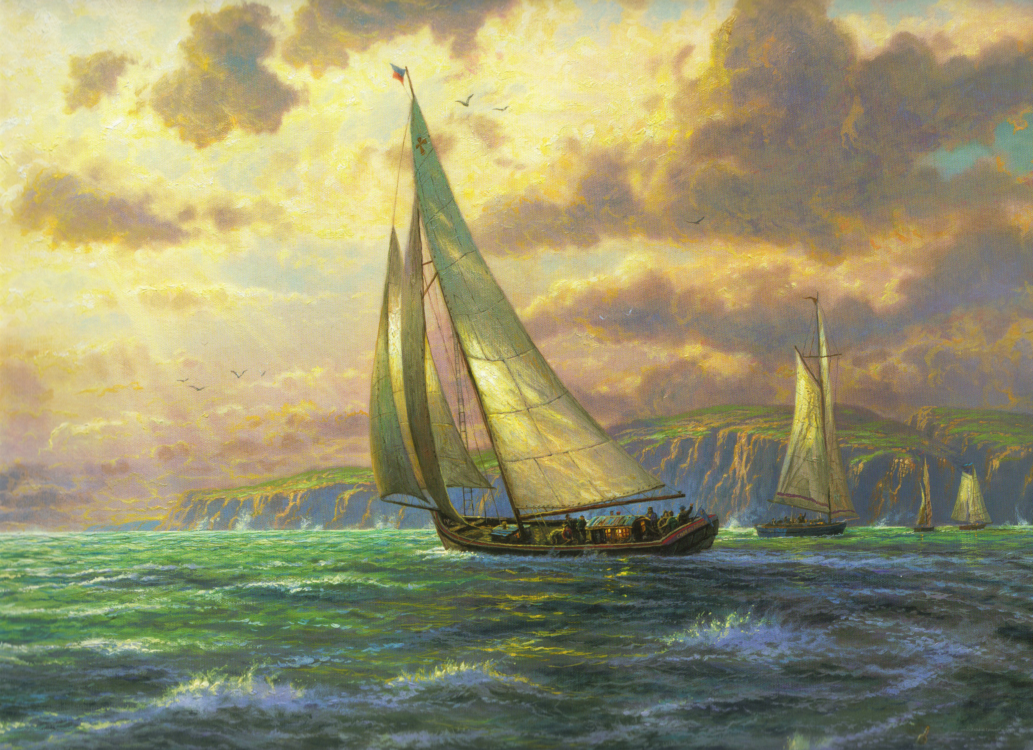 Sailboats at sunset near cliffs