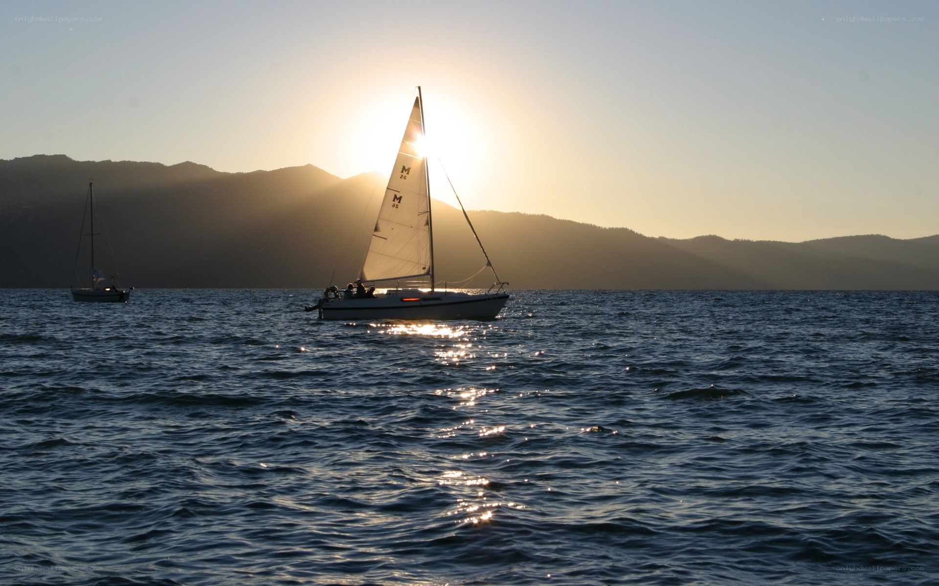 Sailboats at sunset on a lake