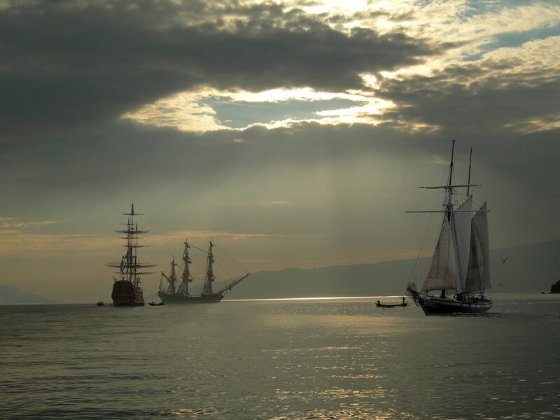 Sailboats at sunset on calm water