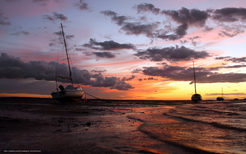 Sailboats at sunset on the shore