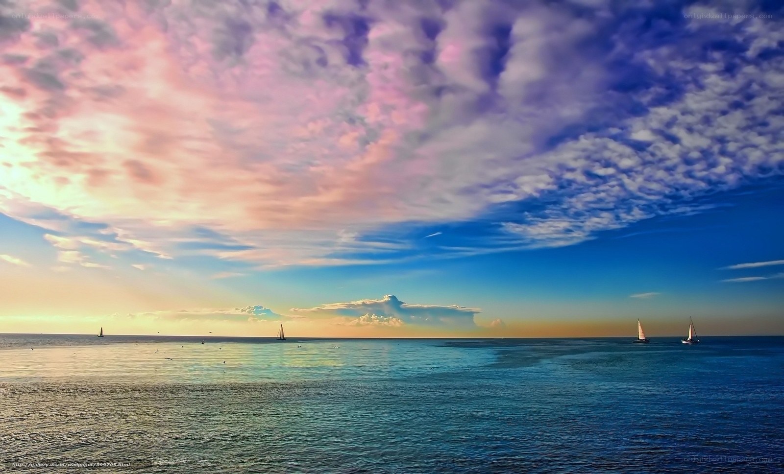 Sailboats at sunset over the sea