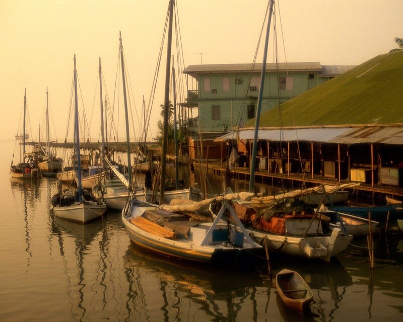 Sailboats docked at a harbor