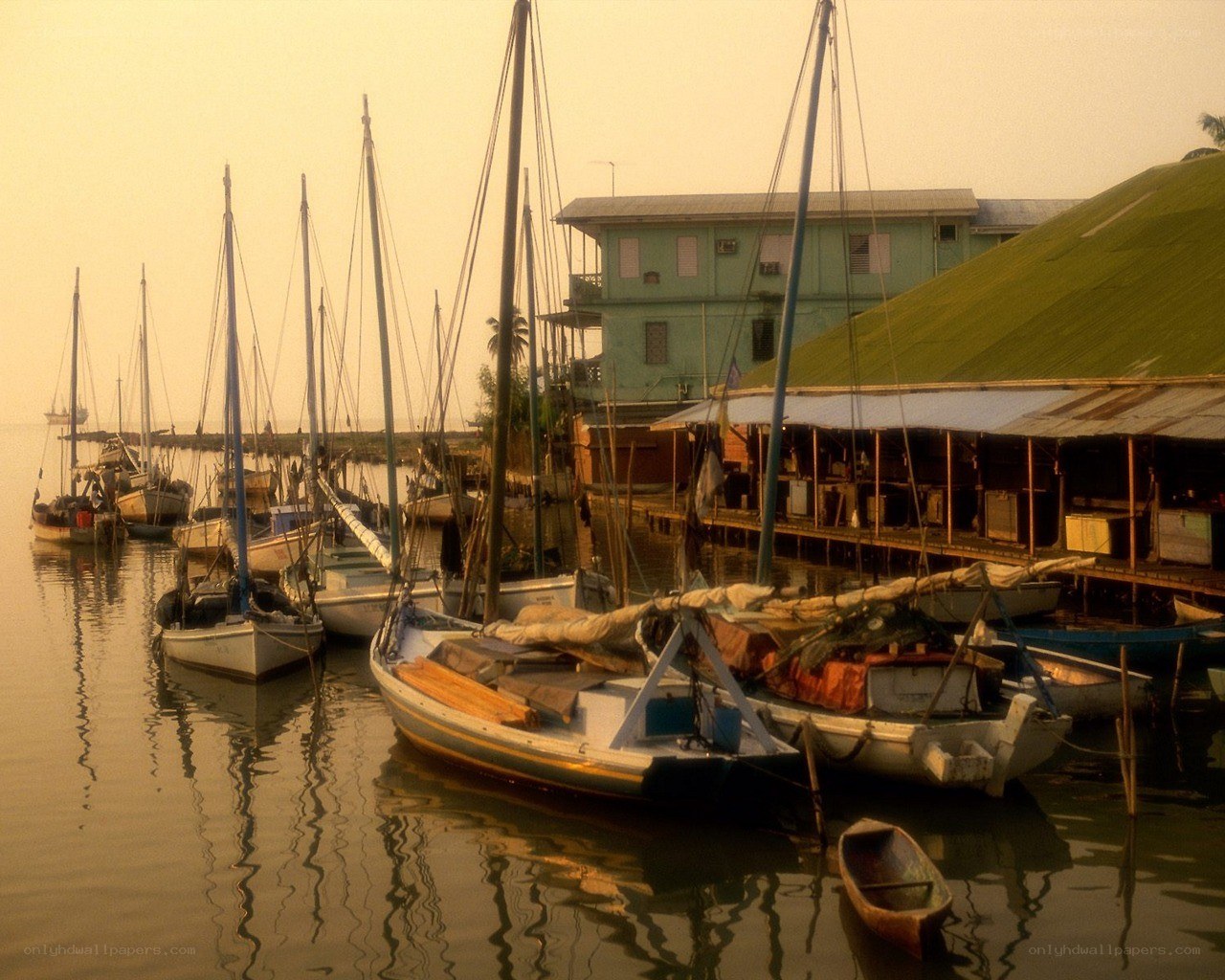 Sailboats docked at a harbor