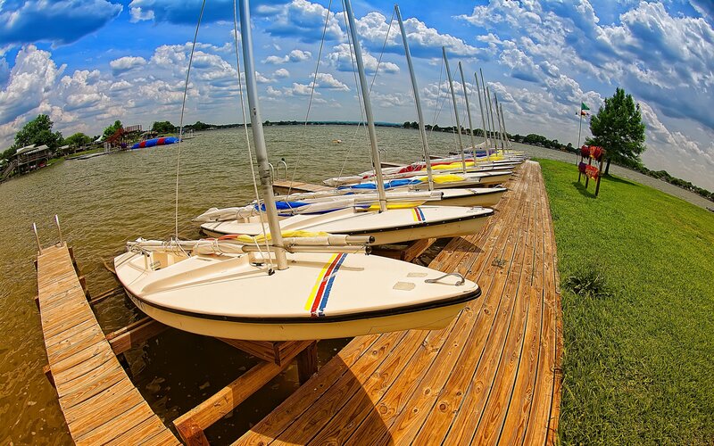 Sailboats docked at a lake