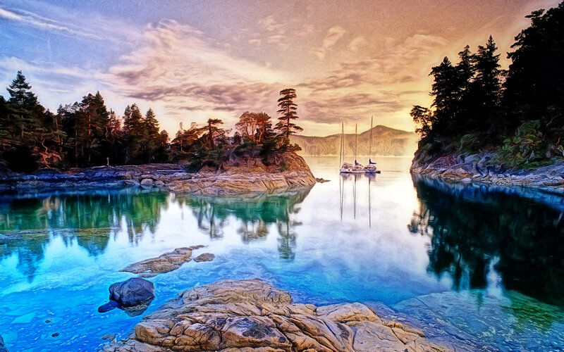 Sailboats in a calm bay at sunset