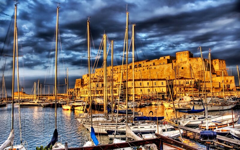 sailboats in a harbor at dusk