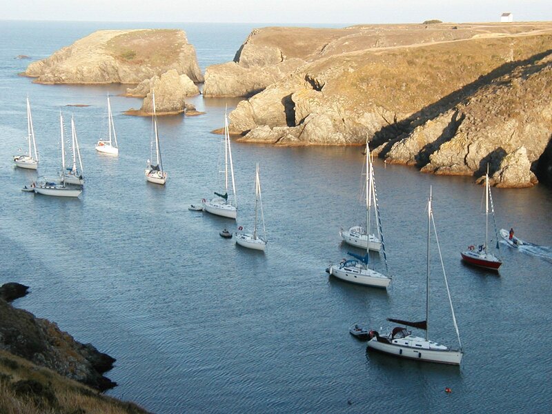 sailboats in a rocky cove