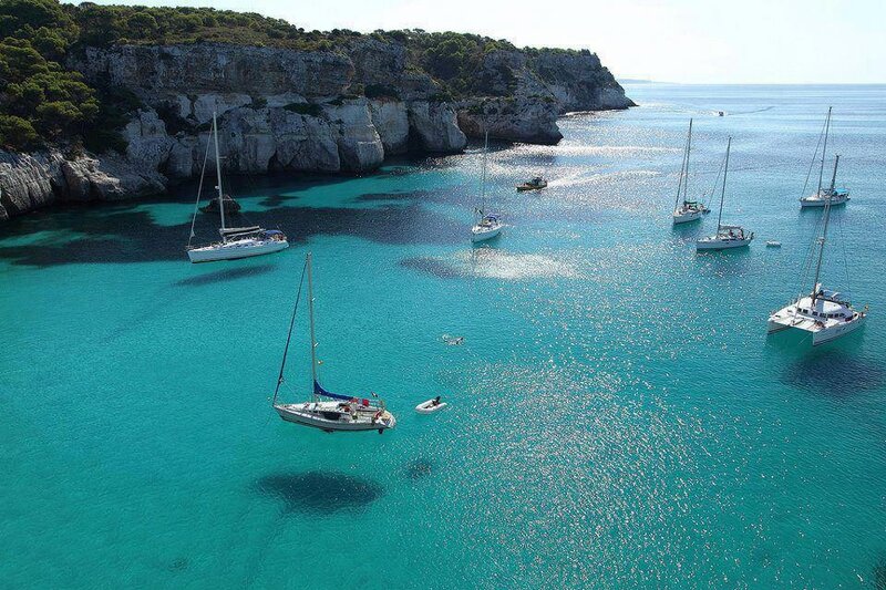 Sailboats in a turquoise cove