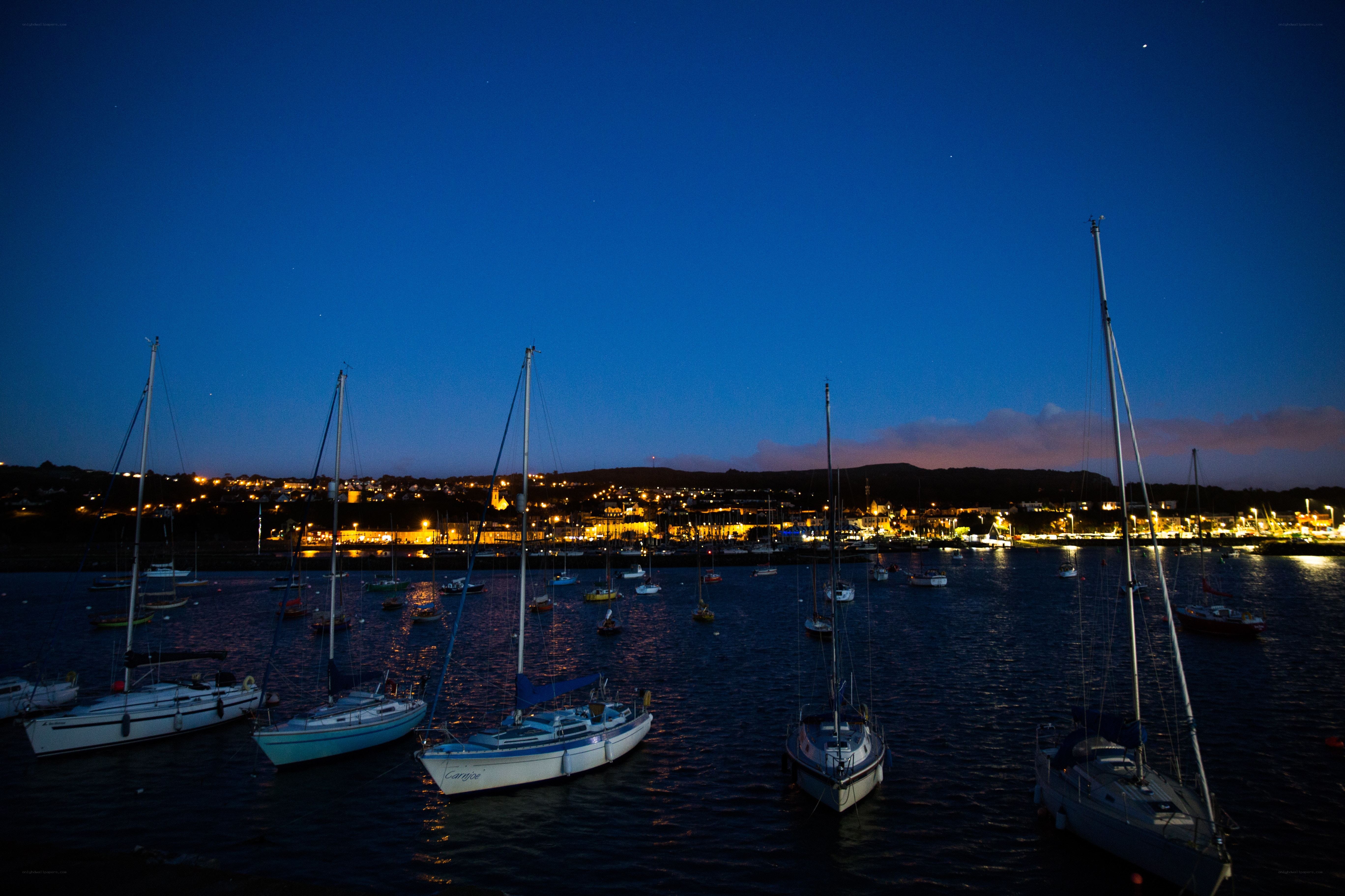 sailboats in harbor at dusk
