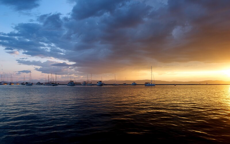 Sailboats in Harbor — Blue, Dramatic, Sunset, Photograph, Clouds, Mountains, Sun