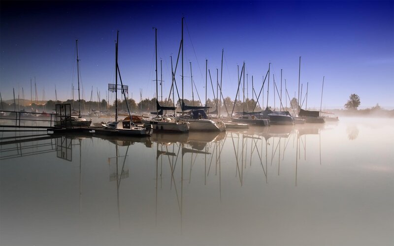 Sailboats in morning mist