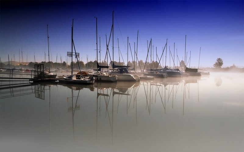 Sailboats in morning mist