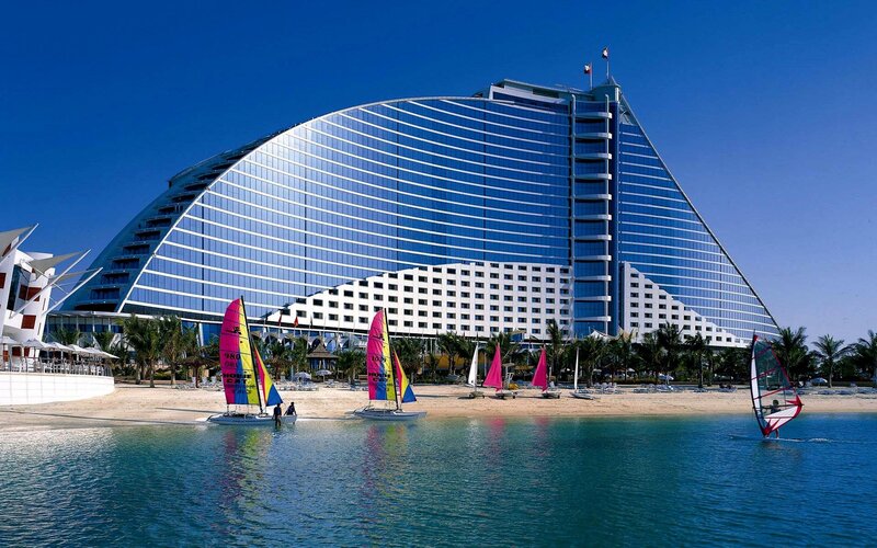 sailboats near a modern hotel