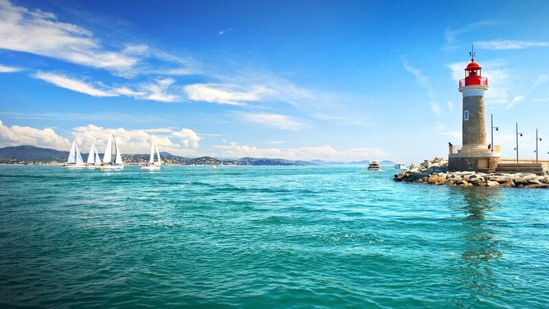 Sailboats Near Lighthouse — Blue