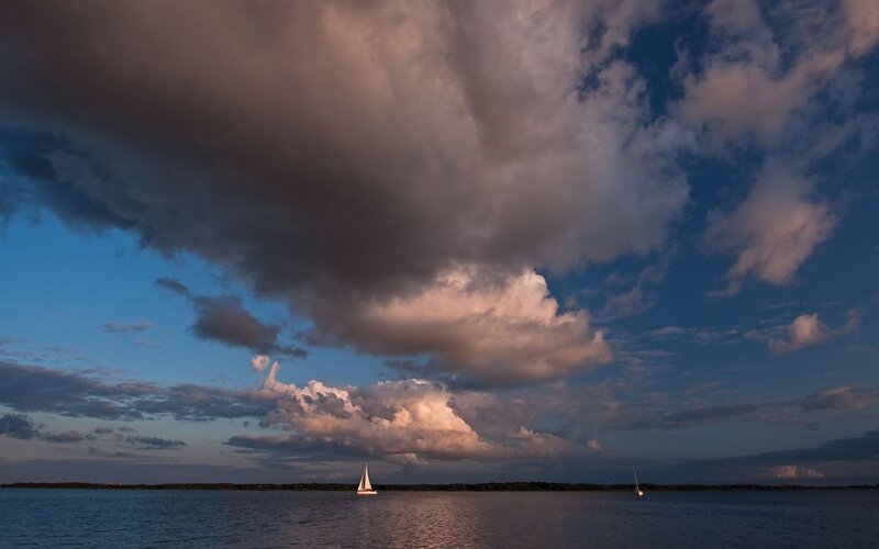 Sailboats on a lake at dusk