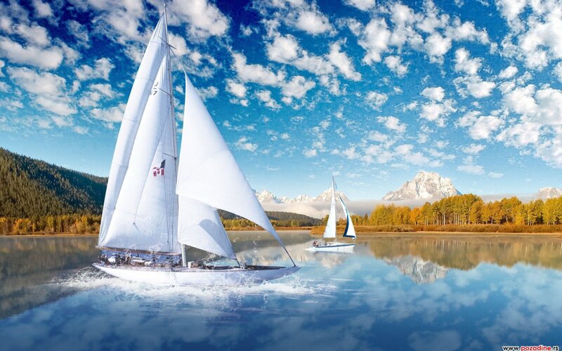 Sailboats on a lake with mountains