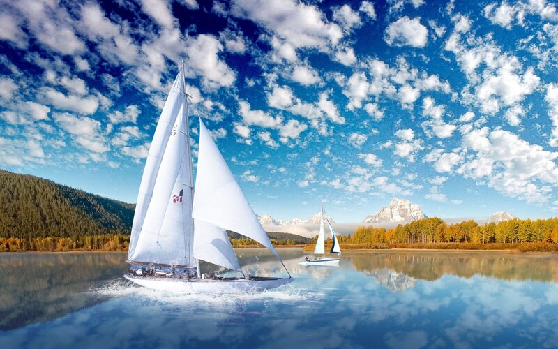 Sailboats on a lake with mountains