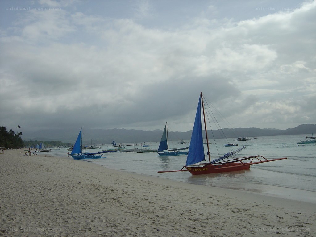 Sailboats on a sandy beach
