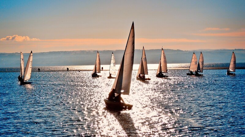 Sailboats on the water at sunset