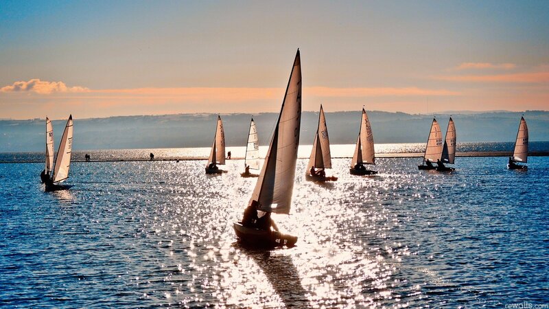 Sailboats on the water at sunset