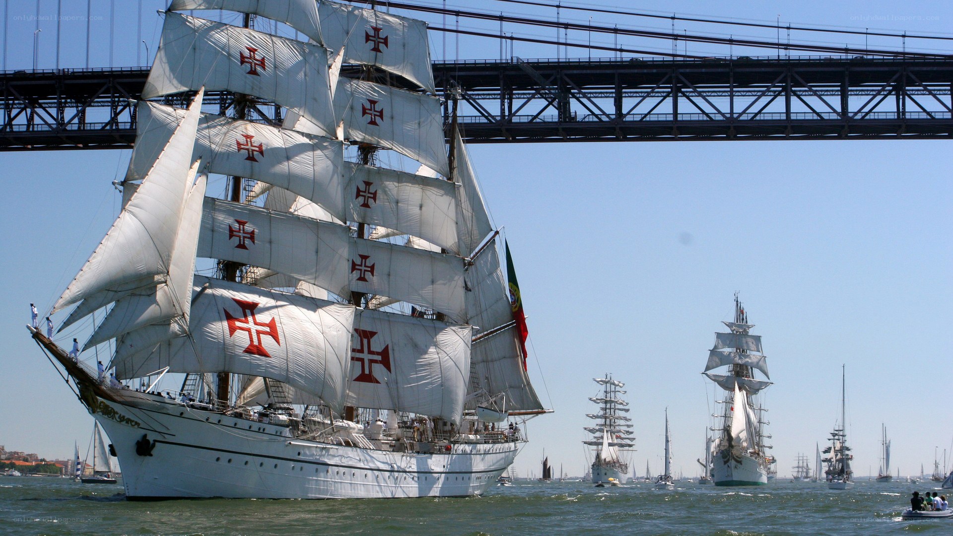 Sailboats under a bridge