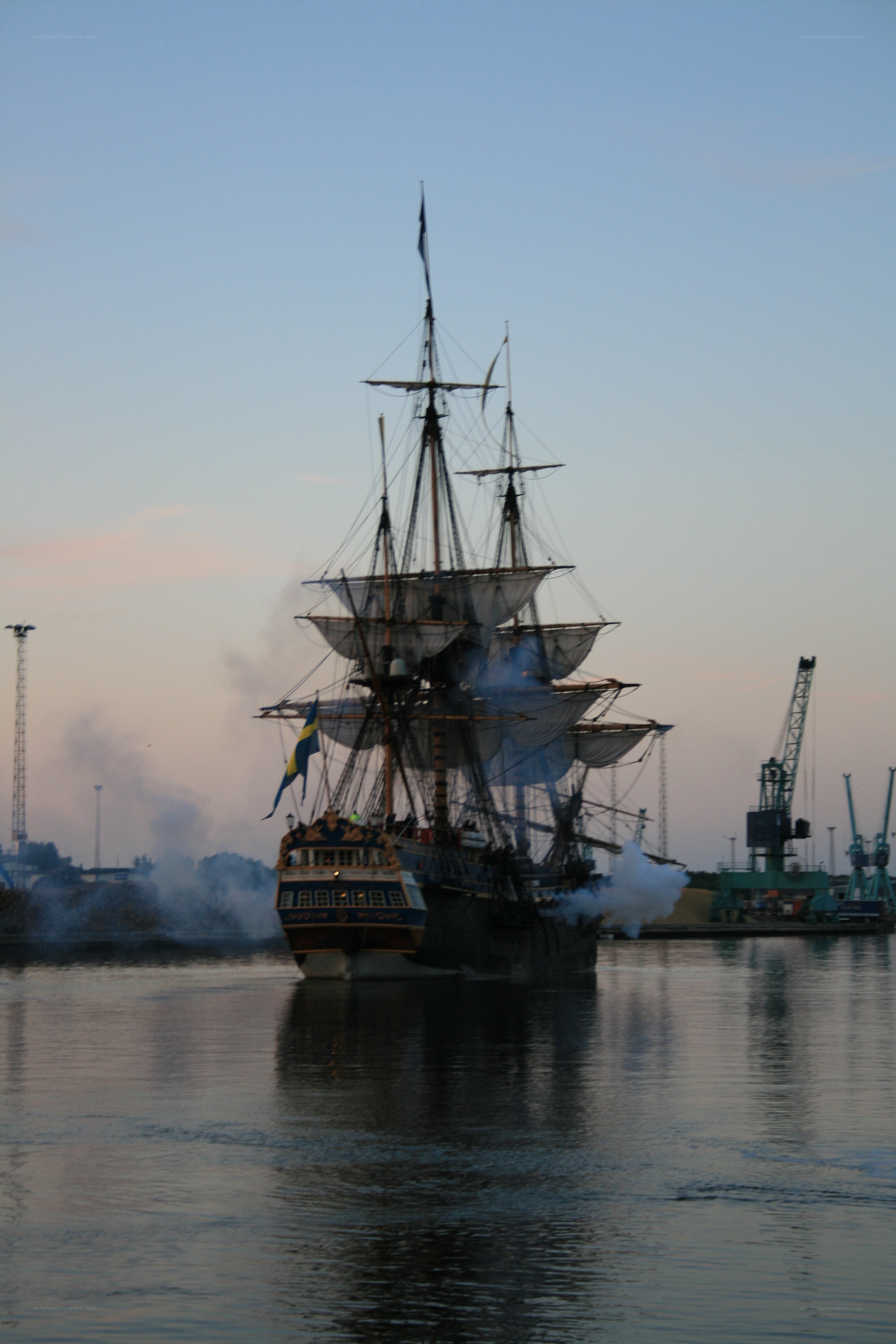 sailing ship in harbor at dusk