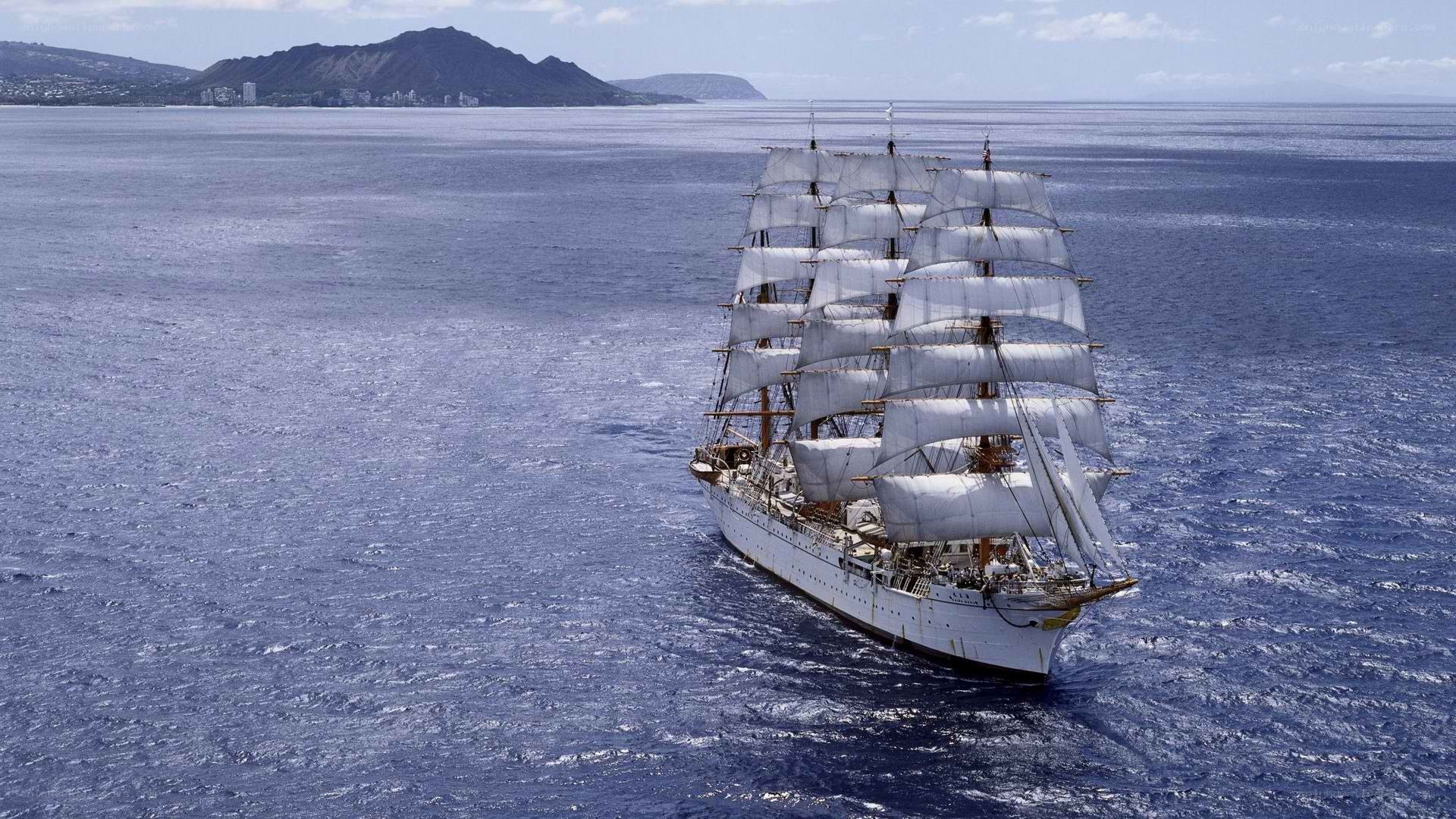 Sailing ship near a mountainous coast