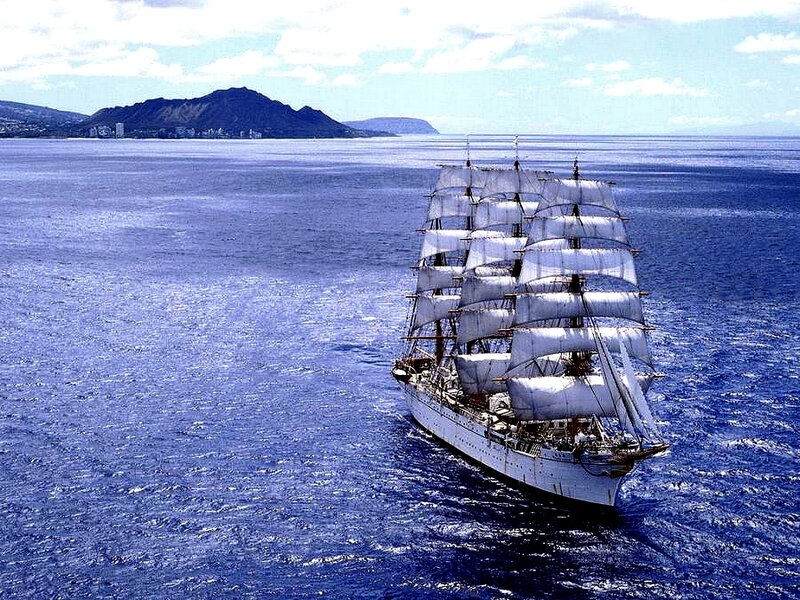 Sailing ship near a mountainous island