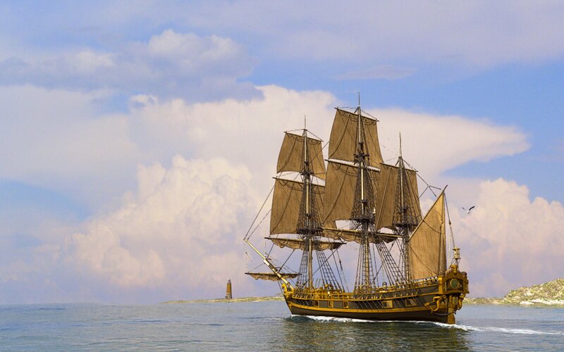sailing ship near lighthouse