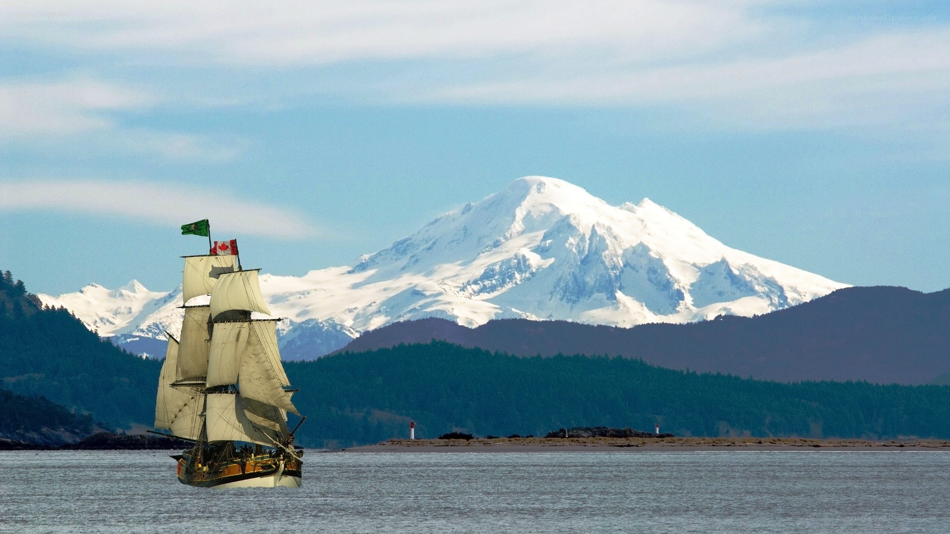Sailing ship near snow-capped mountain