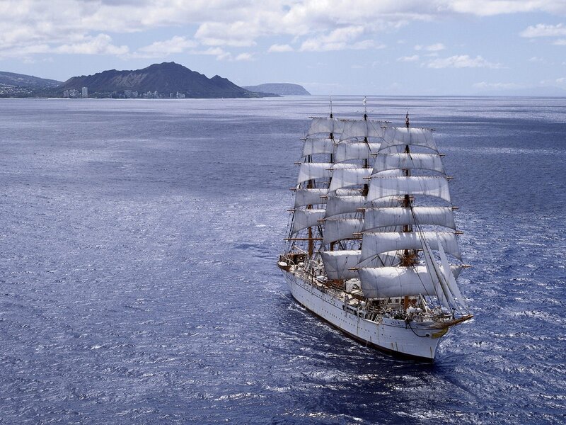 Sailing ship near volcanic island