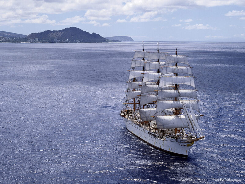 Sailing ship near volcanic island