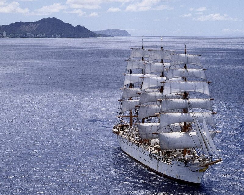 Sailing ship near volcanic island