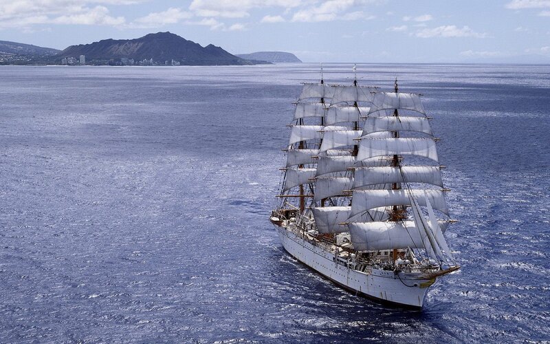 Sailing ship near volcanic island