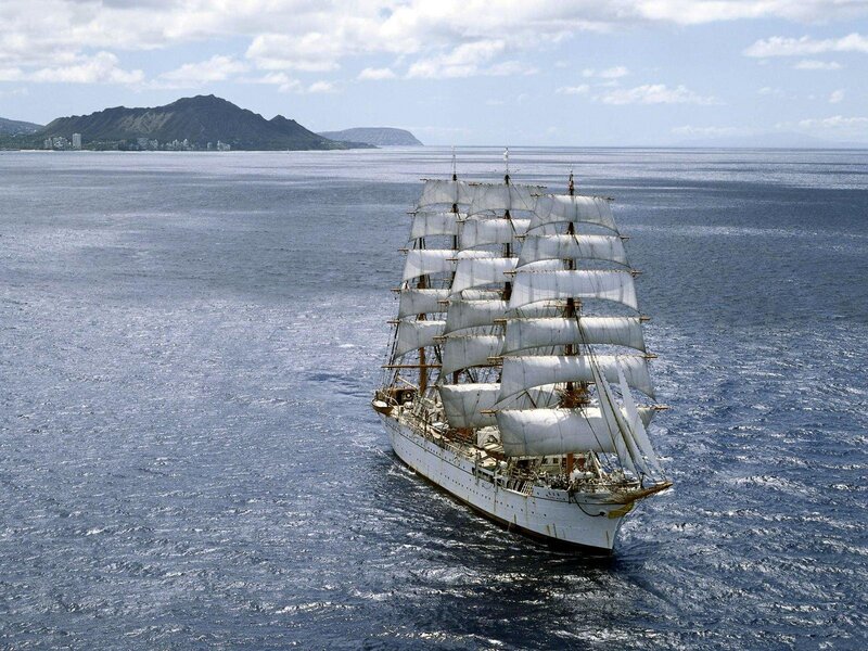 Sailing ship near volcanic island