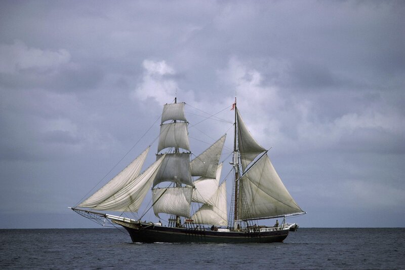 Sailing Ship on Ocean — Gray, Dramatic, Photograph, Cloudy Sky, Sails