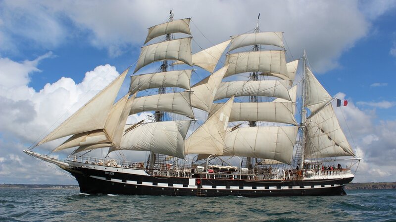 Sailing Ship on Sea — Blue, Serene, Afternoon, Photograph, Sails, Flag