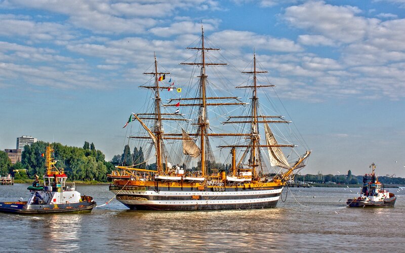 Sailing Ship with Tugboats — Blue
