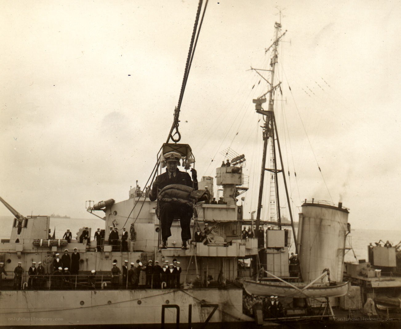 Sailor being hoisted on a ship